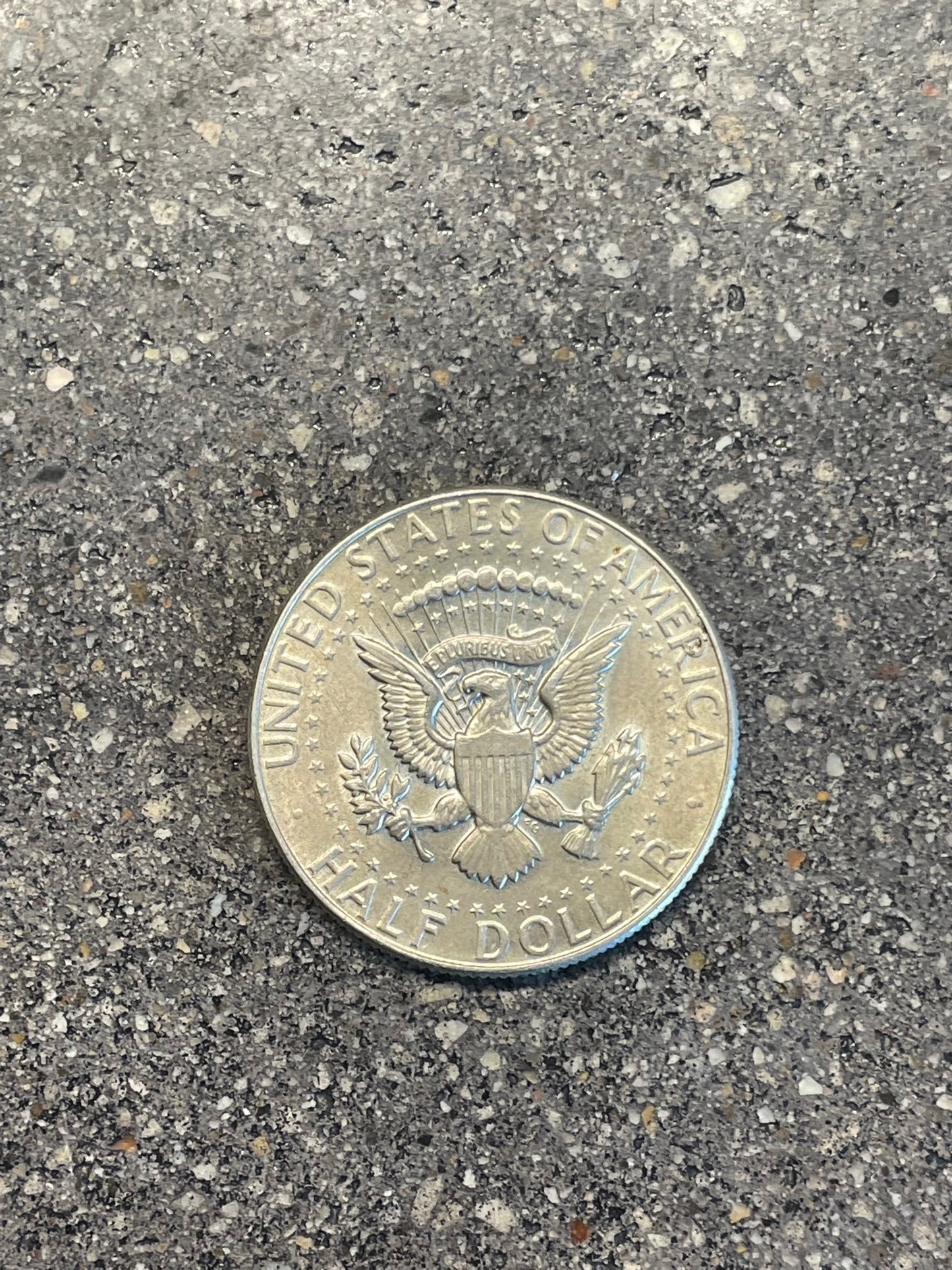JFK Silver Half Dollar Coin (reverse) on a concrete background - Mountainstruck Coin Jewelry