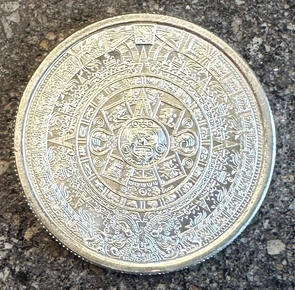Mexico Aztec Calendar 1/4 oz Silver Round (back) on a dark concrete background.
- Mountainstruck Coin Jewelry