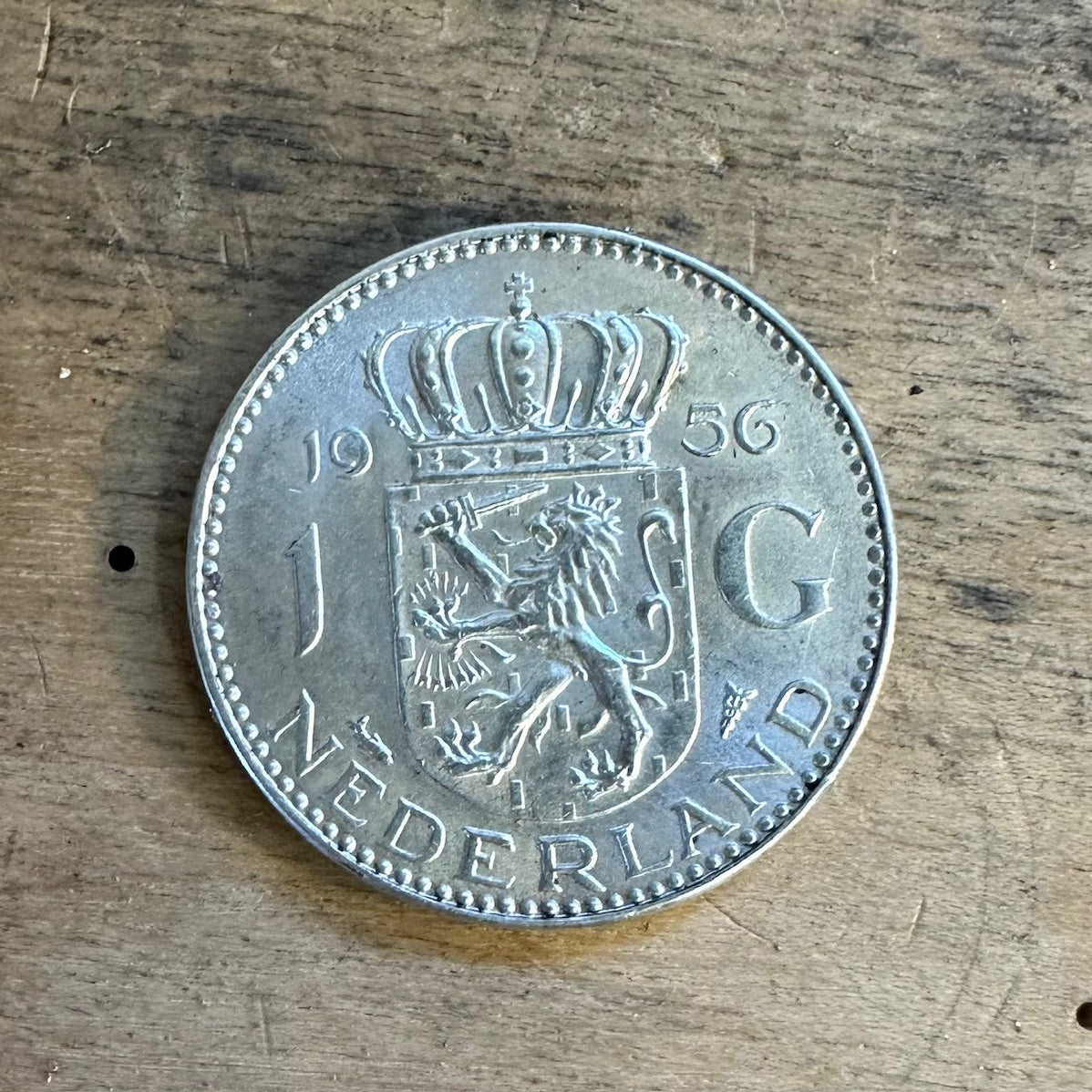 Netherlands 1 Gulden Silver Coin back on wooden surface. - Mountainstruck Coin Jewelry