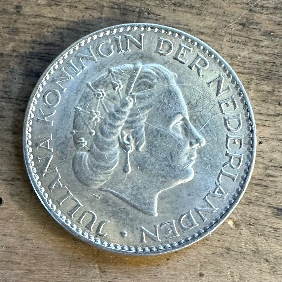 Netherlands 1 Gulden Silver Coin front on wooden surface. - Mountainstruck Coin Jewelry