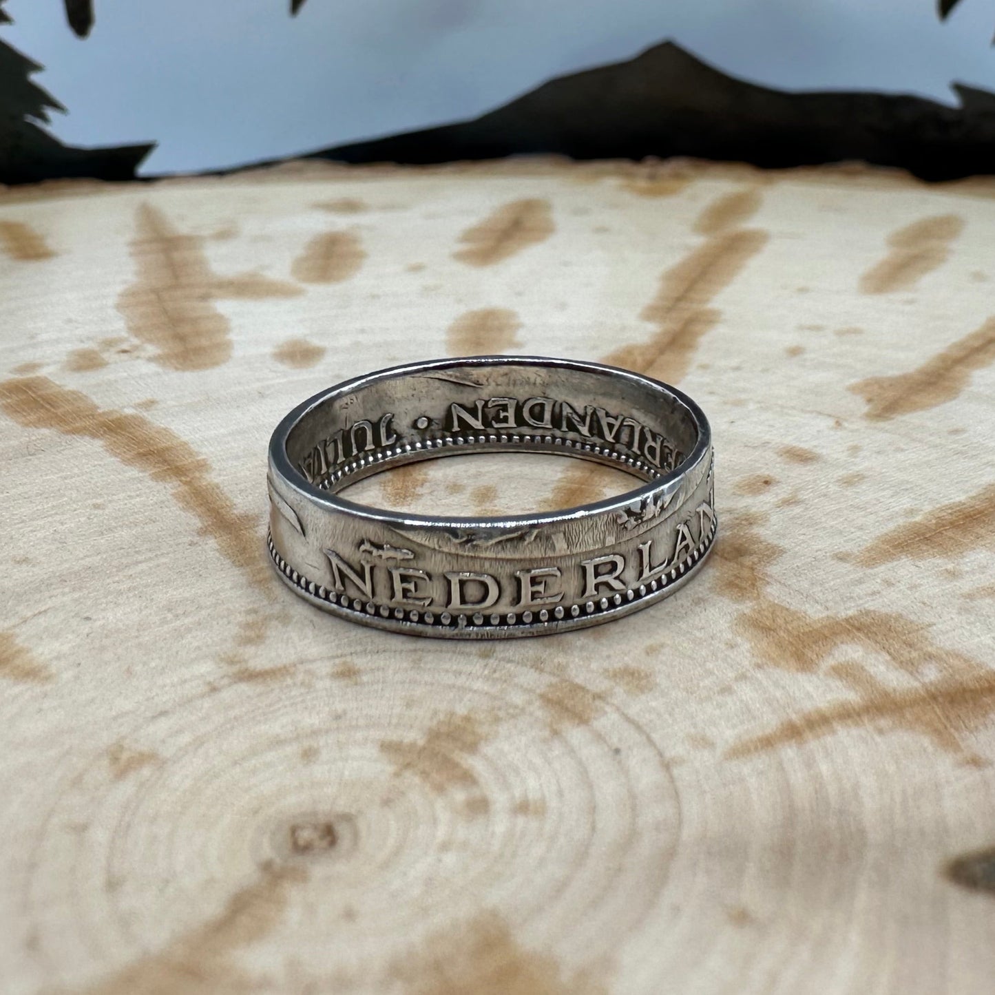 Netherlands 1 Gulden Silver Coin Ring on a wood background. - Mountainstruck Coin Jewelry