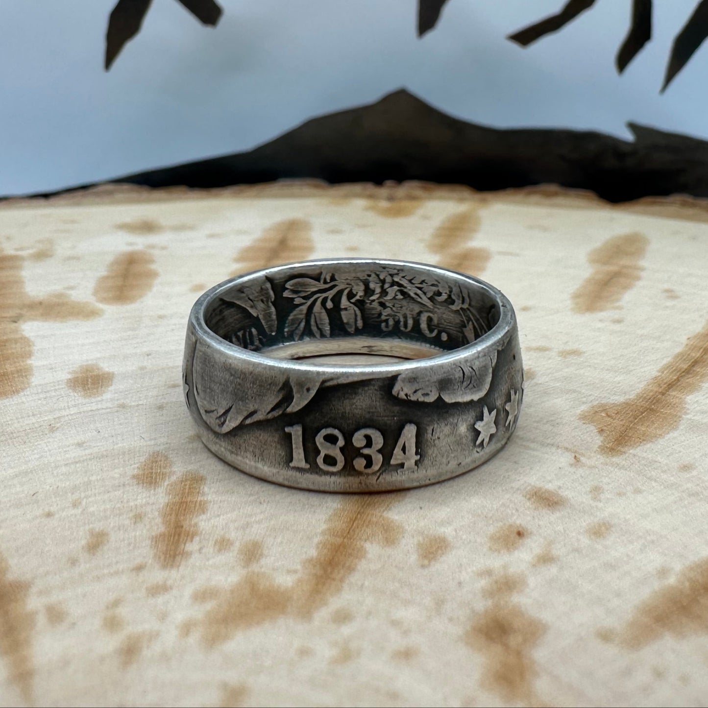 (Rare) Capped Bust Liberty Silver Half Dollar Coin Ring on a wood background. - Mountainstruck Coin Jewelry