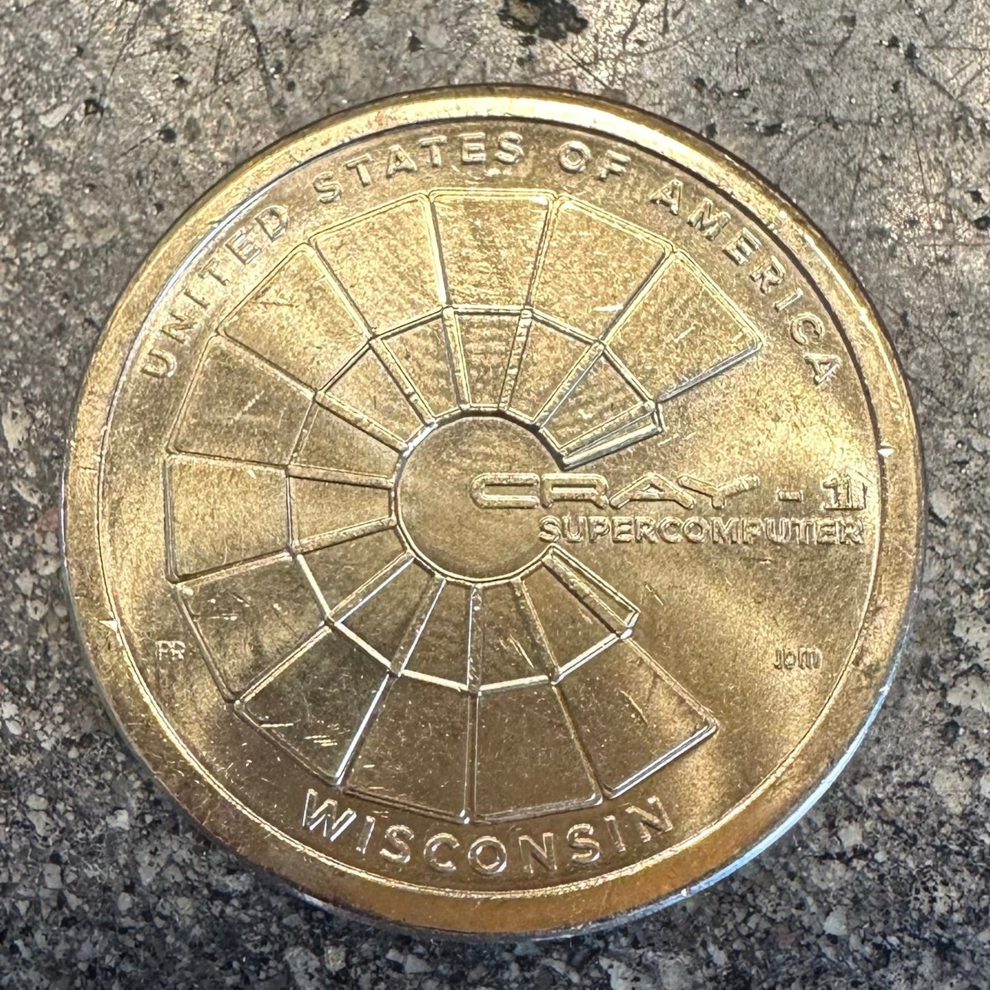 U.S. 2026 "CRAY-1 Supercomputer" 1 Dollar Coin on a concrete background. - Mountainstruck Coin Jewelry