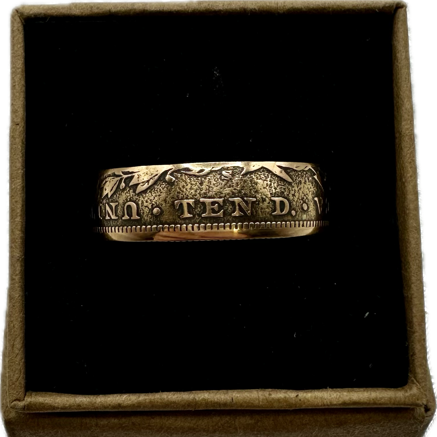 U.S. Solid Gold Eagle $10 Coin Ring in a brown kraft box on a black velvet background. - Mountainstruck Coin Jewelry