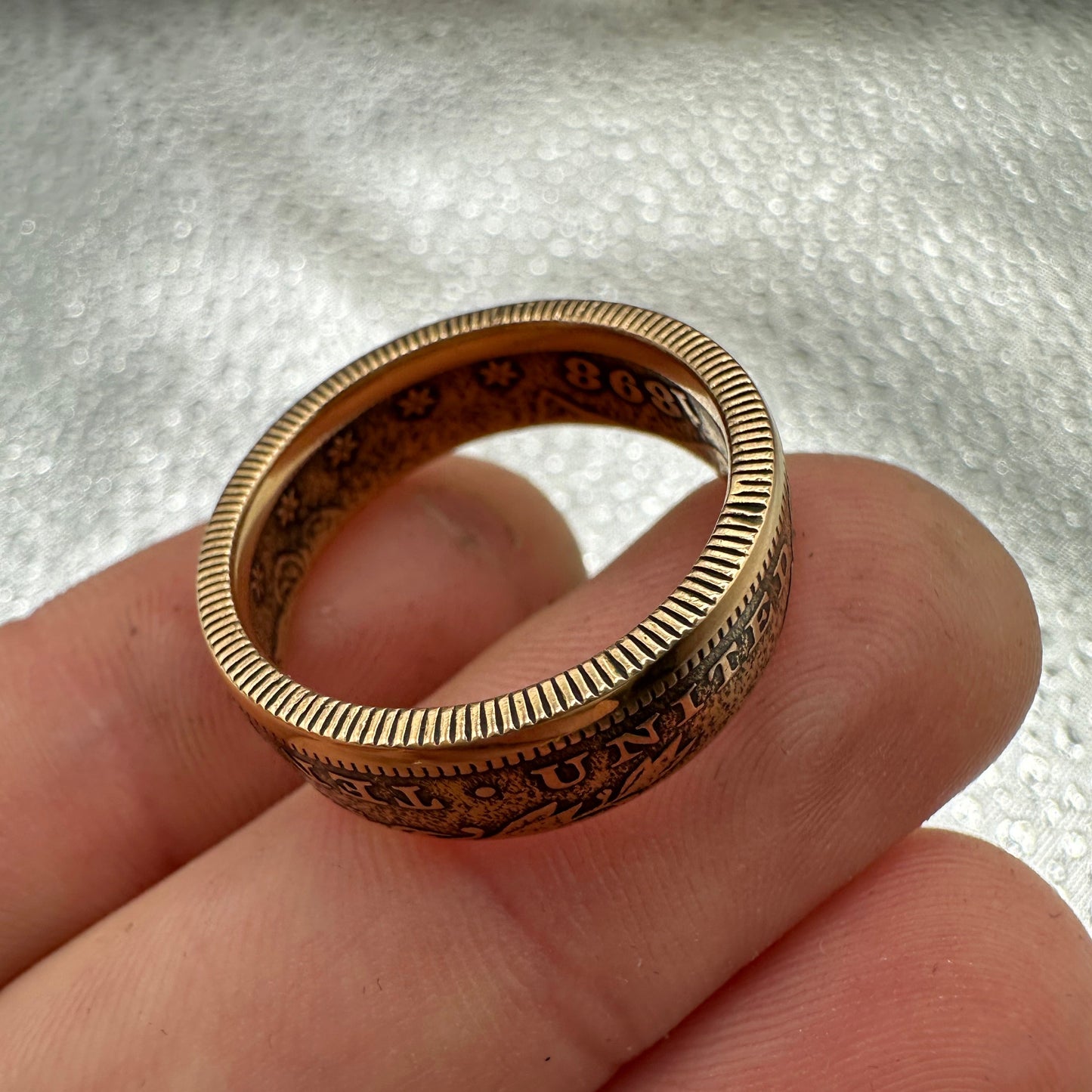 U.S. Solid Gold Eagle $10 Coin Ring on a hand with a silver background. - Mountainstruck Coin Jewelry