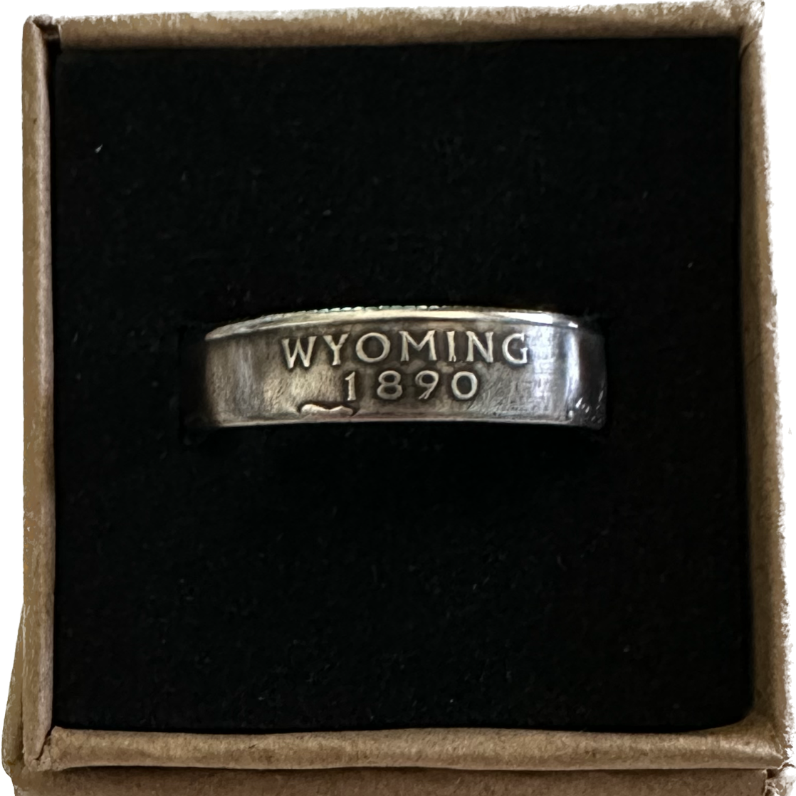 U.S. State Quarter Coin Ring featuring Wyoming in a brown kraft box on a black velvet background. - Mountainstruck Coin Jewelry