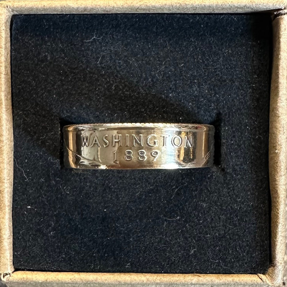 U.S. State Quarter Coin Ring featuring Washington in a brown kraft box on a black velvet background. - Mountainstruck Coin Jewelry
