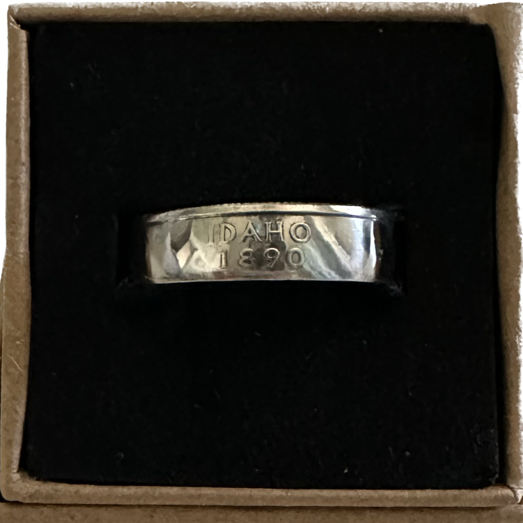 U.S. Silver State Quarter Coin Ring featuring Idaho in a brown kraft box on a black velvet background. - Mountainstruck Coin Jewelry