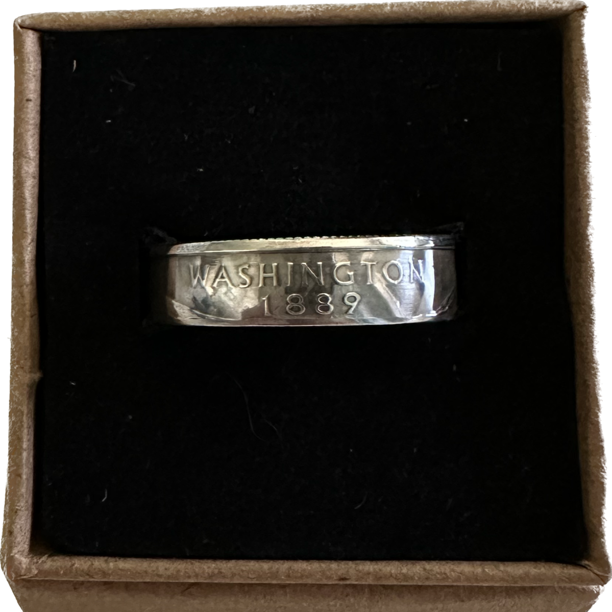 U.S. Silver State Quarter Coin Ring featuring Washington in a brown kraft box on a black velvet background. - Mountainstruck Coin Jewelry