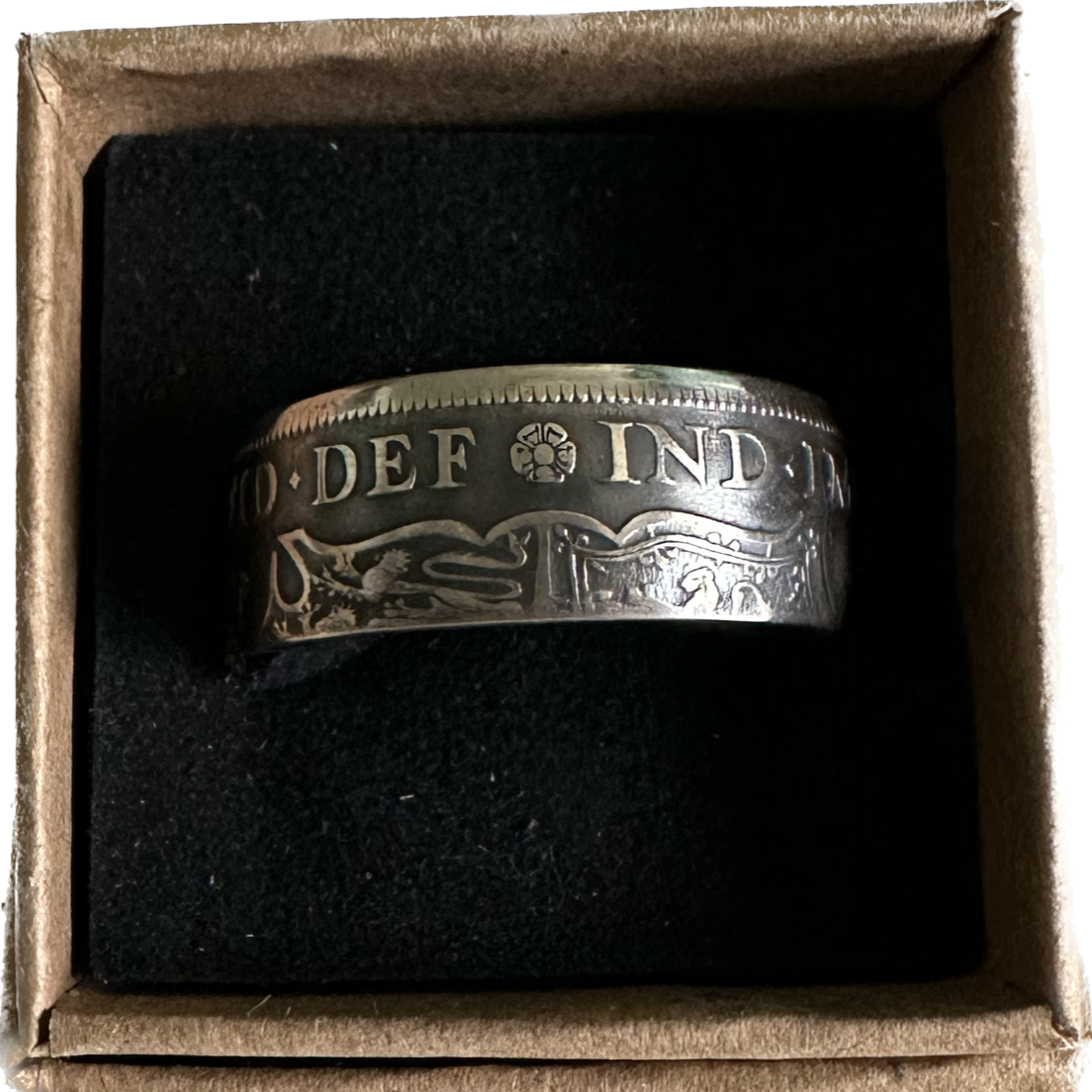 UK Half Crown Silver Coin Ring (1927-1936, G.B.) in a brown kraft box on a black velvet background. - Mountainstruck Coin Jewelry