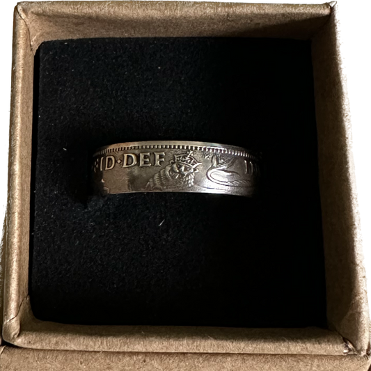 UK One Shilling Silver Coin Ring (shine) in a brown kraft box on a black velvet background. - Mountainstruck Coin Jewelry