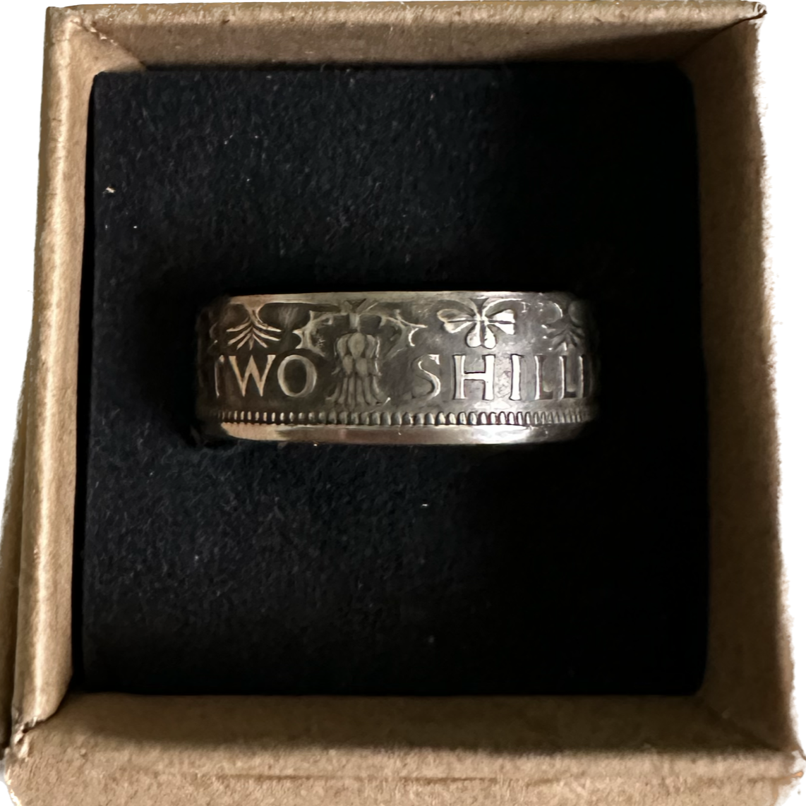 UK Two Shillings Coin Ring in a brown kraft box on a black velvet background. - Mountainstruck Coin Jewelry