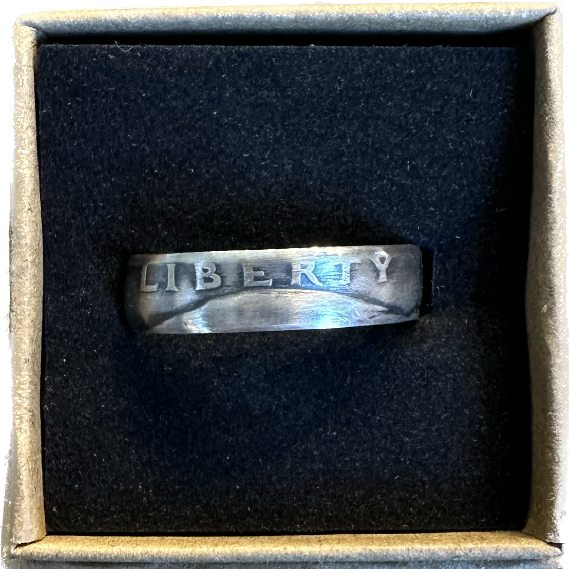 Washington Silver Quarter Coin Ring (front) in a brown kraft box on a black velvet background. - Mountainstruck Coin Jewelry