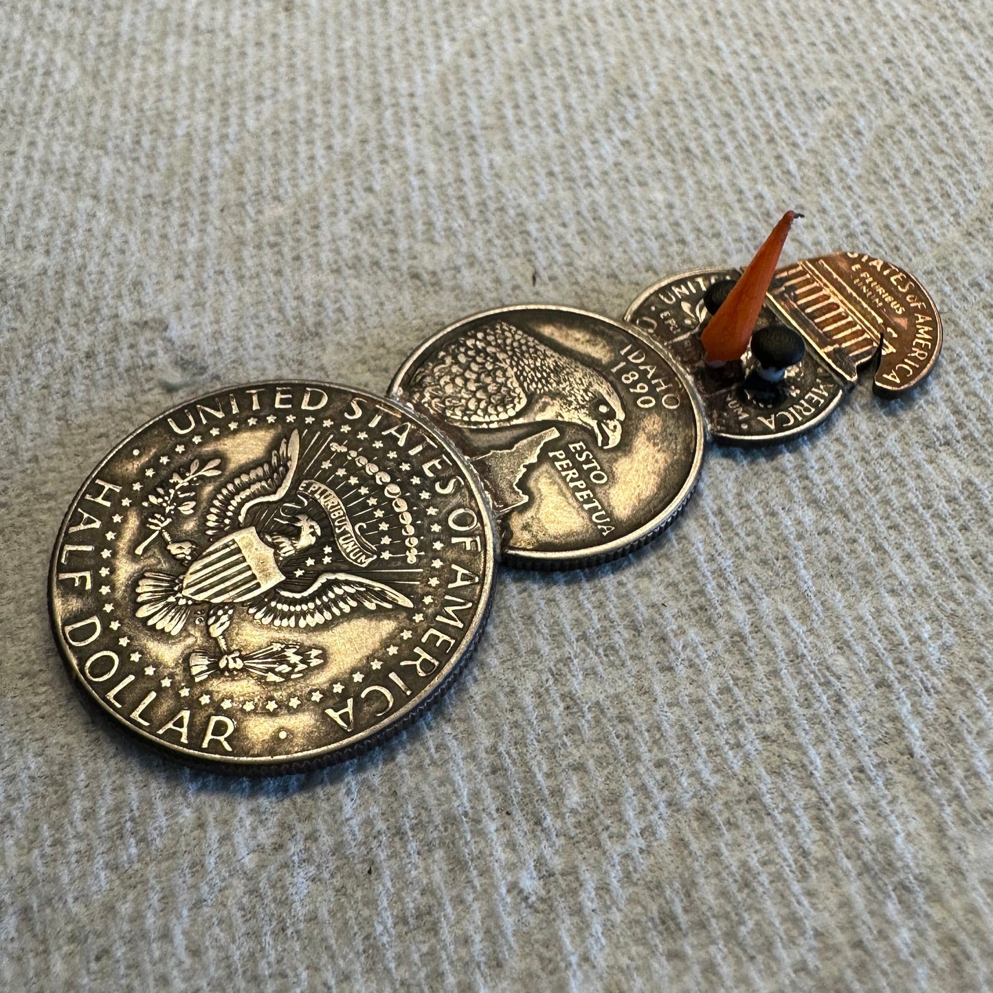 2024 Snowman Coin Christmas Ornament with a selection of U.S. coins (penny, dime, Idaho Quarter, and 2024 uncirculated half dollar) soldered into a snowman on a white textured background. - Mountainstruck Coin Jewelry