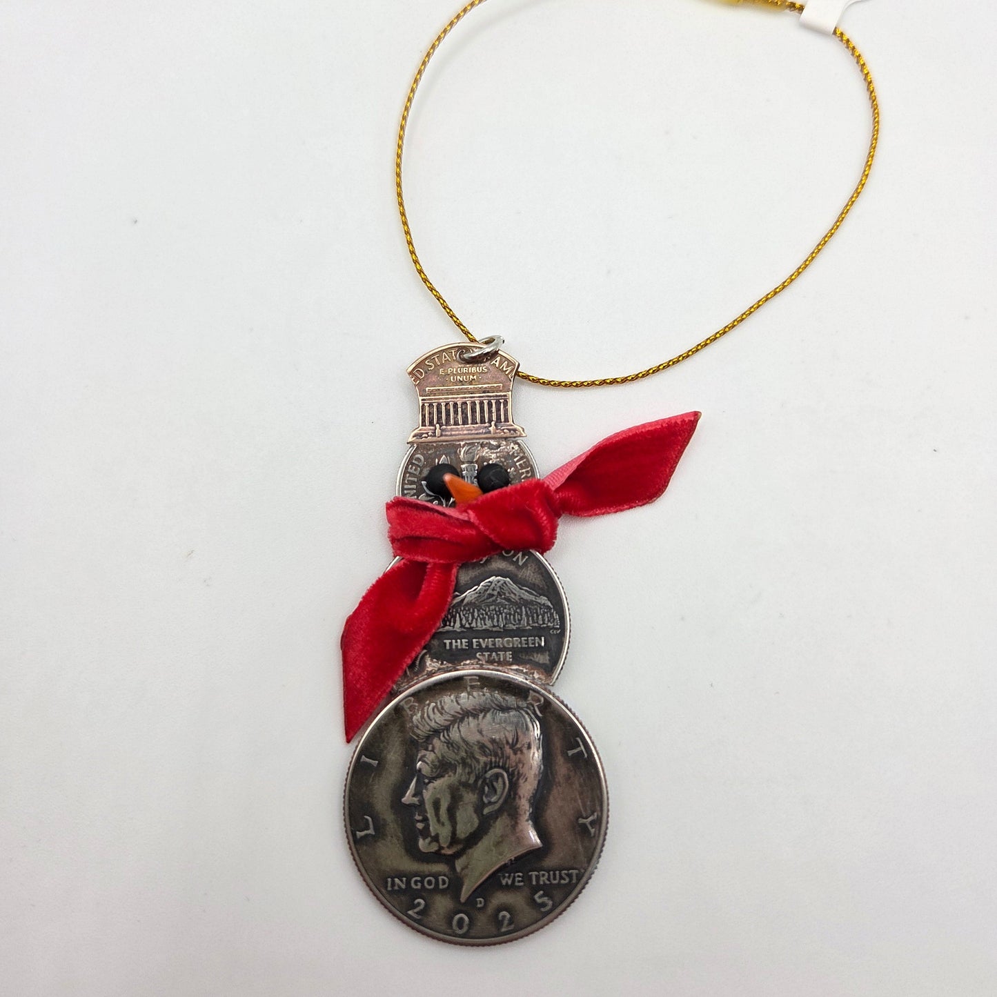 2025 Snowman Coin Christmas Ornament with a selection of U.S. coins (penny, dime, state quarter, and 2025 uncirculated half dollar) soldered into a snowman with a red ribbon scarf and golden tassel on a white background. - Mountainstruck Coin Jewelry