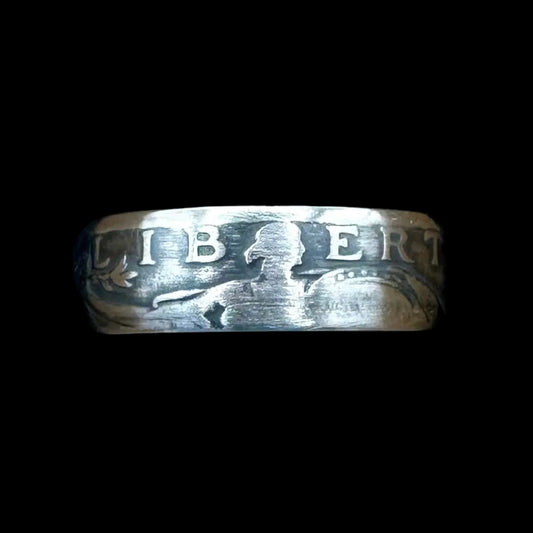 U.S. Standing Liberty Quarter Silver Coin Ring in a brown kraft box on a black velvet background. - Mountainstruck Coin Jewelry