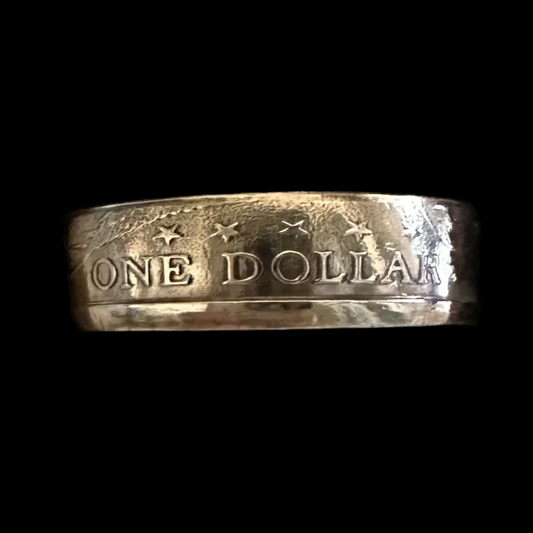 U.S. Sacagawea Dollar Coin Ring in a brown kraft box on a black velvet background.- Mountainstruck Coin Jewelry