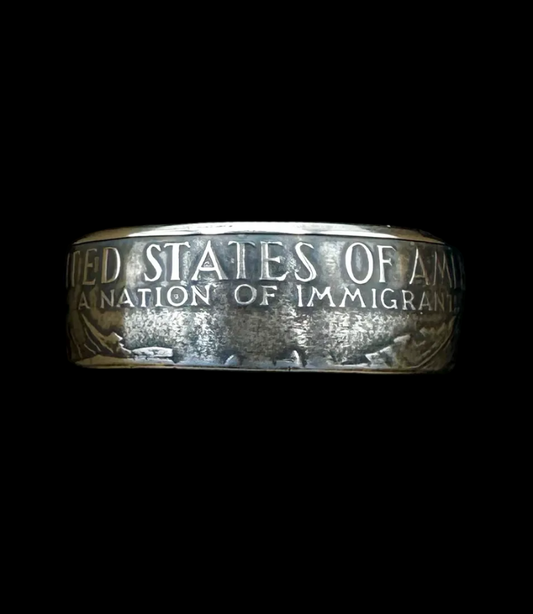 U.S. "A Nation of Immigrants" Half Dollar Coin Ring patina in a brown kraft box on a black velvet background. - Mountainstruck Coin Jewelry