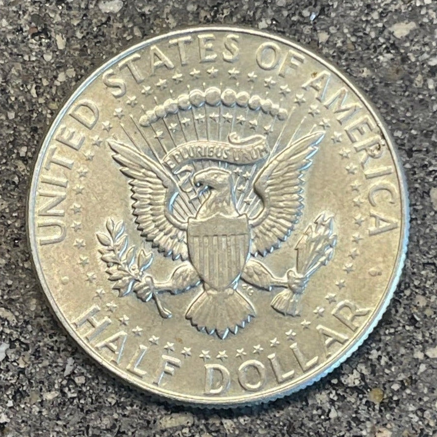 U.S. JFK Silver Half Dollar Coin back on a concrete background. - Mountainstruck Coin Jewelry
