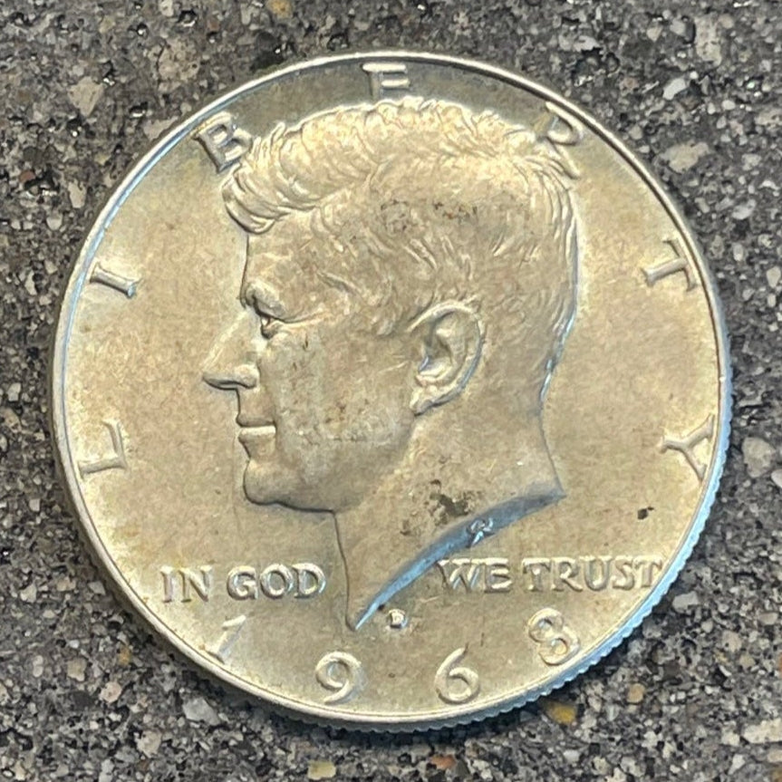 U.S. JFK Silver Half Dollar Coin front on a concrete background. - Mountainstruck Coin Jewelry