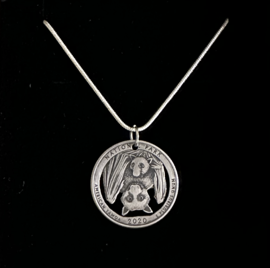 U.S. American Samoa National Park US Quarter Coin Necklace (Bats!) on a black velvet background.