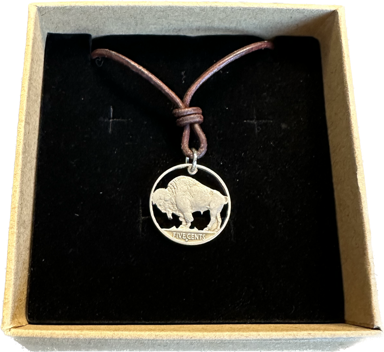 U.S. Buffalo Nickel (Reverse) Coin Necklace with a leather cord in a brown kraft box on a black velvet background.