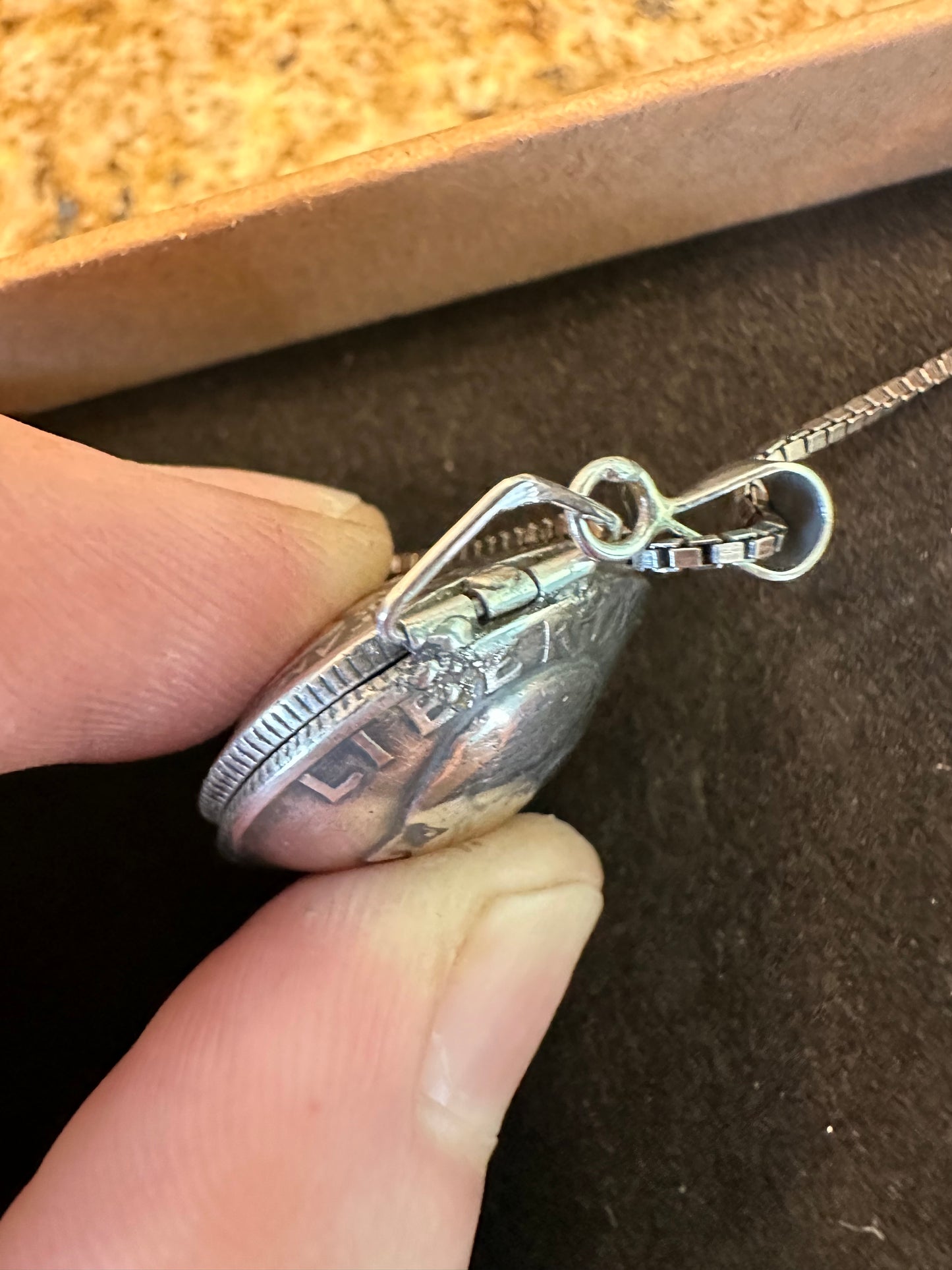 U.S. Silver Quarter Hand Crafted Coin Locket Necklace showing the opening mechanism.