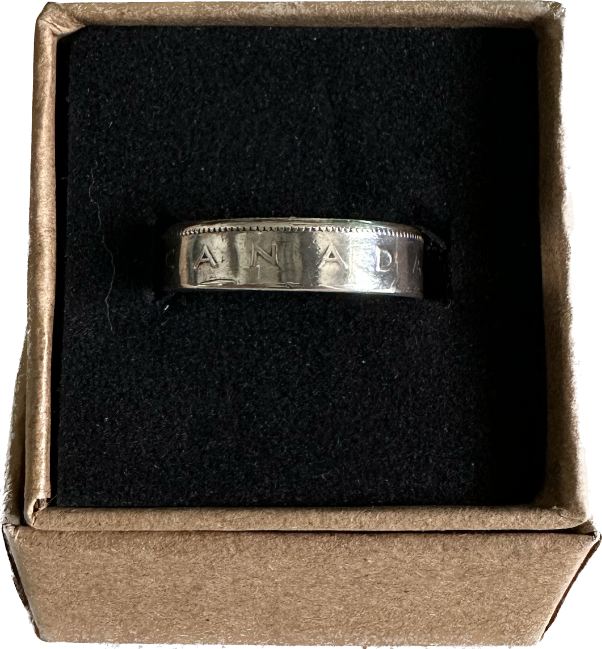 Canada 25 Cents Silver Coin Ring in a brown kraft box on a black velvet background.