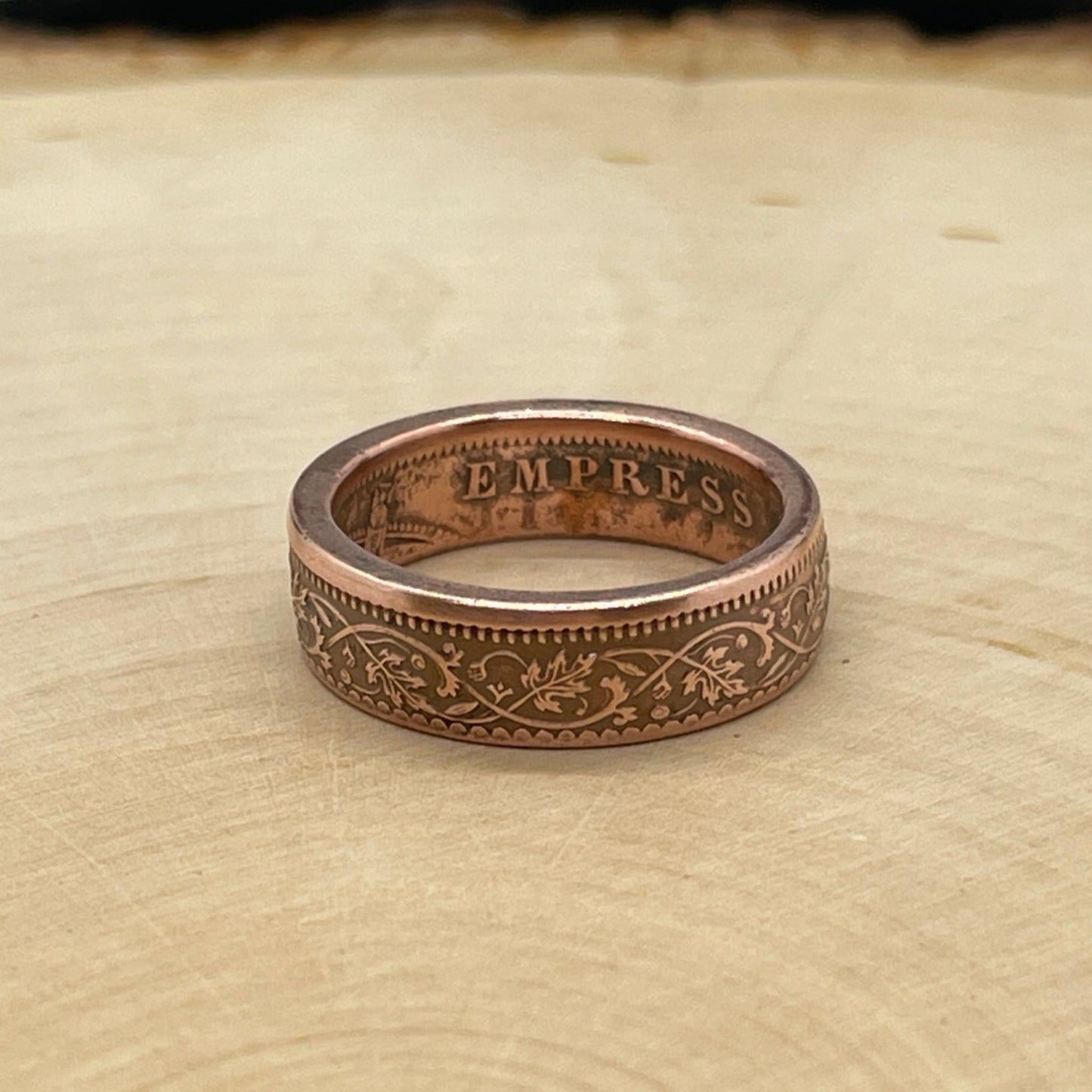 India Quarter Anna Coin Ring on a light wood round.