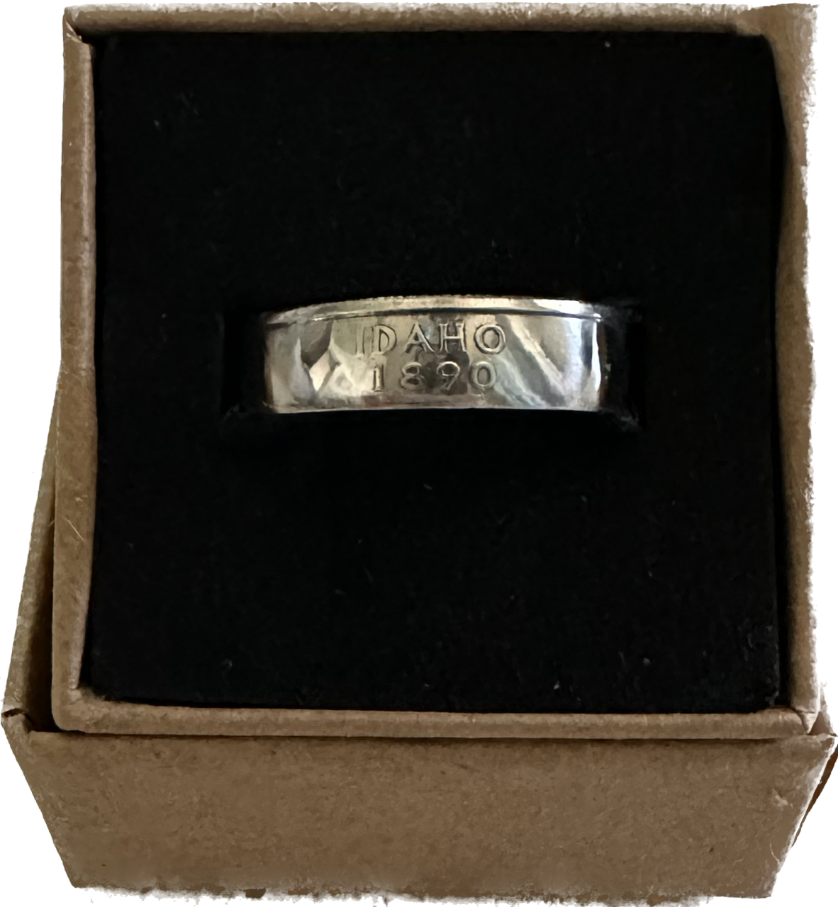 U.S. Silver State Quarter Coin Ring featuring Idaho in a brown kraft box on a black velvet background.