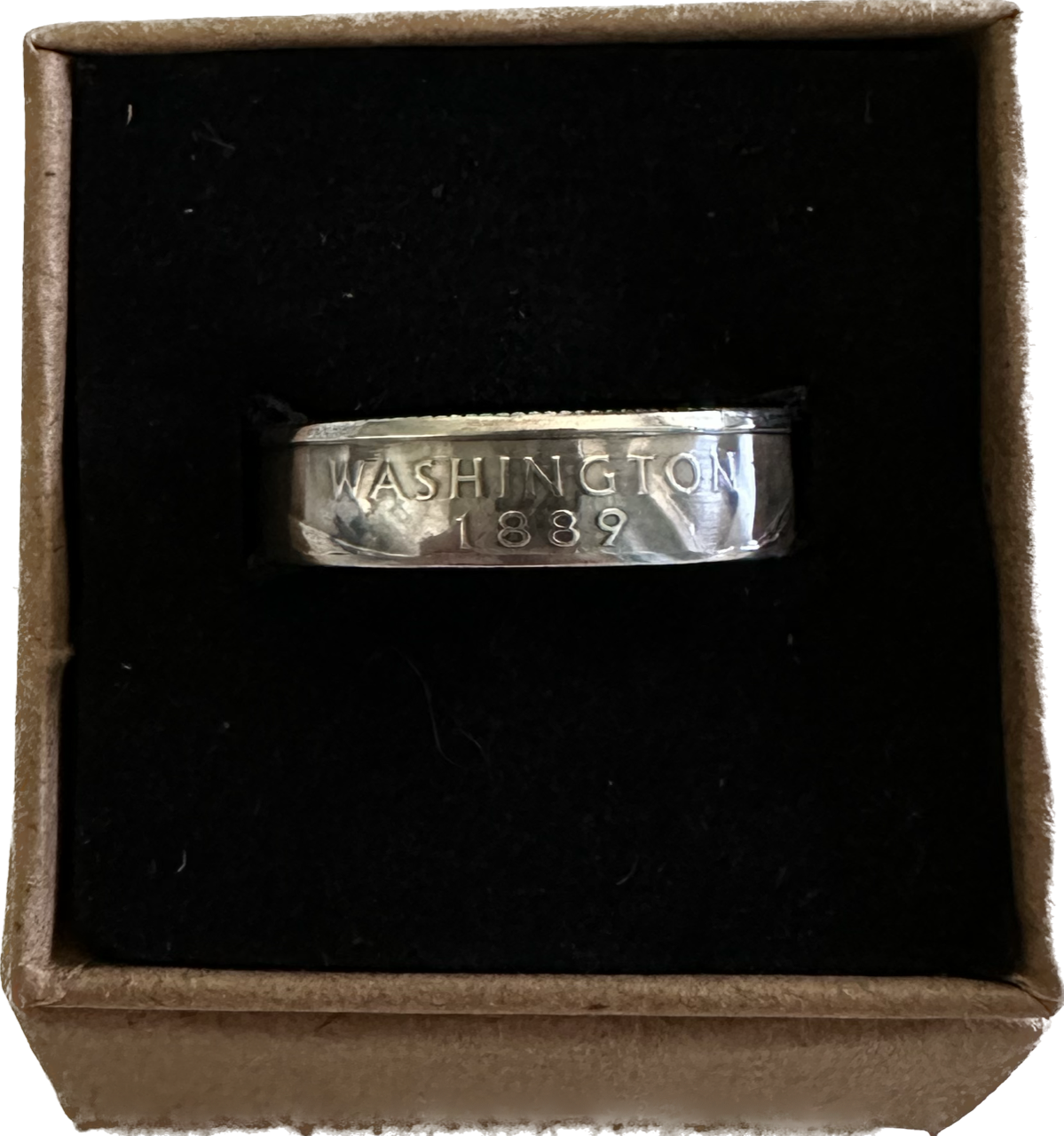 U.S. Silver State Quarter Coin Ring featuring Washington in a brown kraft box on a black velvet background.