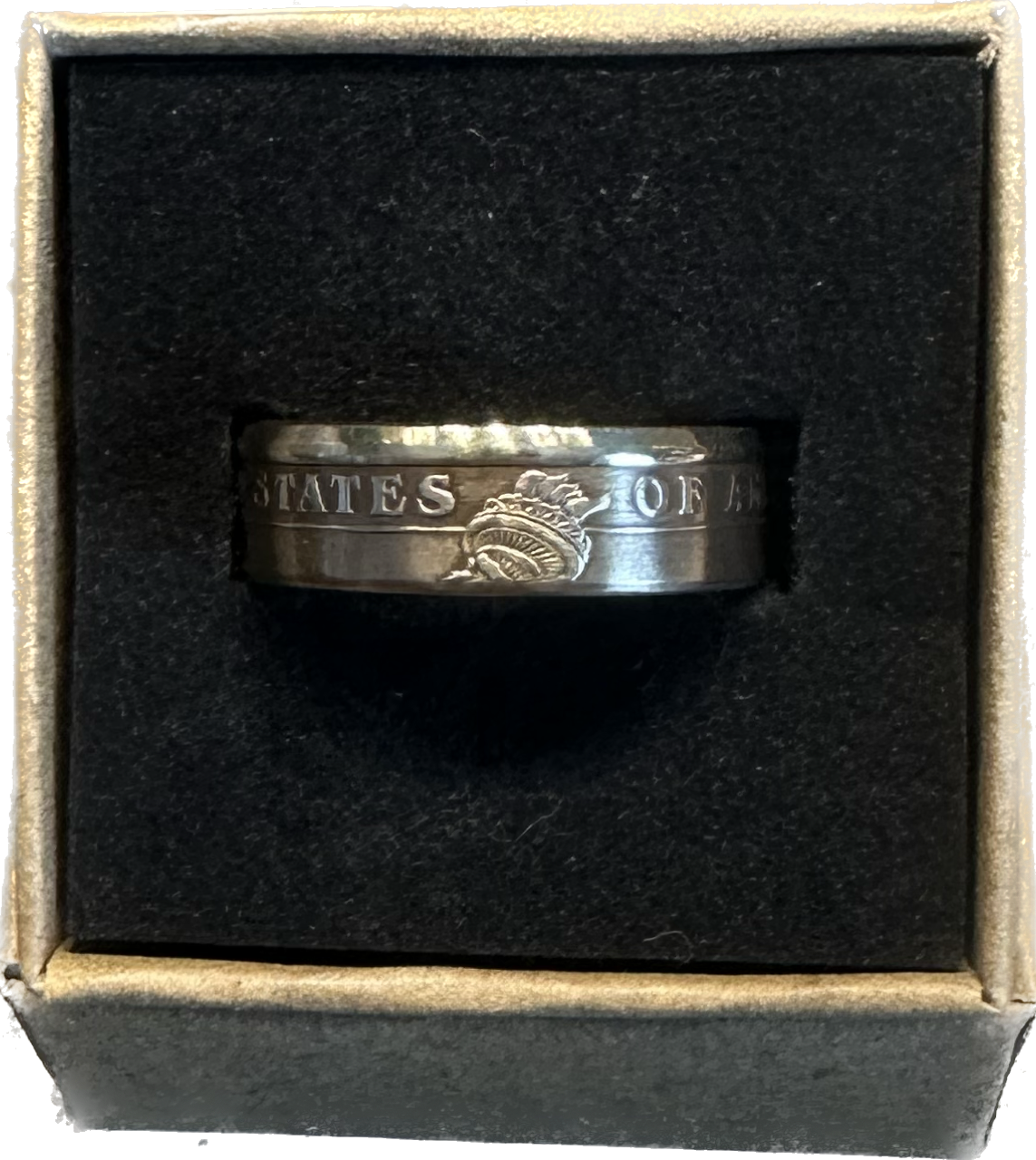 Presidential Gold Dollar Coin Ring in a brown craft box on a black velvet background.