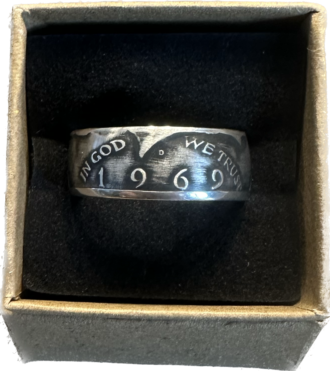 JFK Silver Half Dollar Coin Ring (front) in a brown kraft box on a black velvet background.