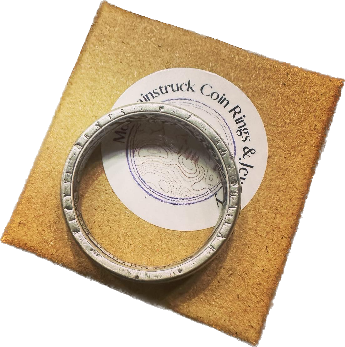 (Rare) Capped Bust Liberty Silver Half Dollar Coin Ring edge with inscription on brown kraft box.