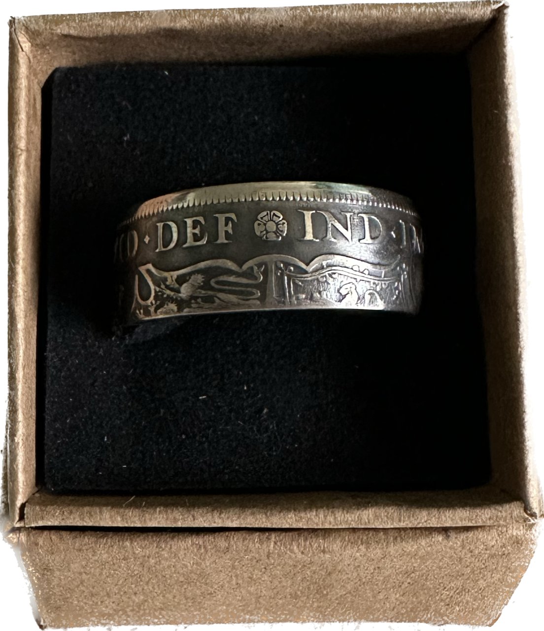 UK Half Crown Silver Coin Ring (1927-1936, G.B.) in a brown kraft box on a black velvet background.