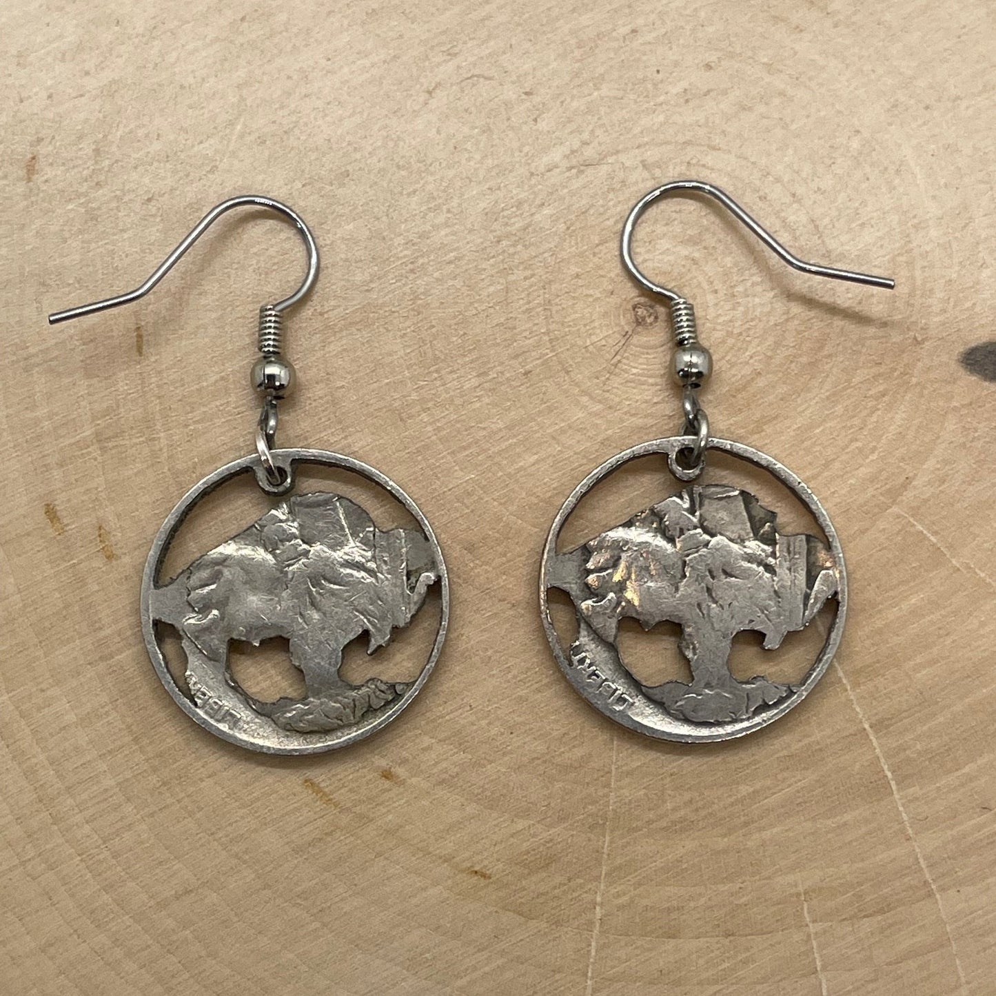U.S. Buffalo Nickel Hand Cut Coin Earrings backside on a light wood round. - Mountainstruck Coin Jewelry