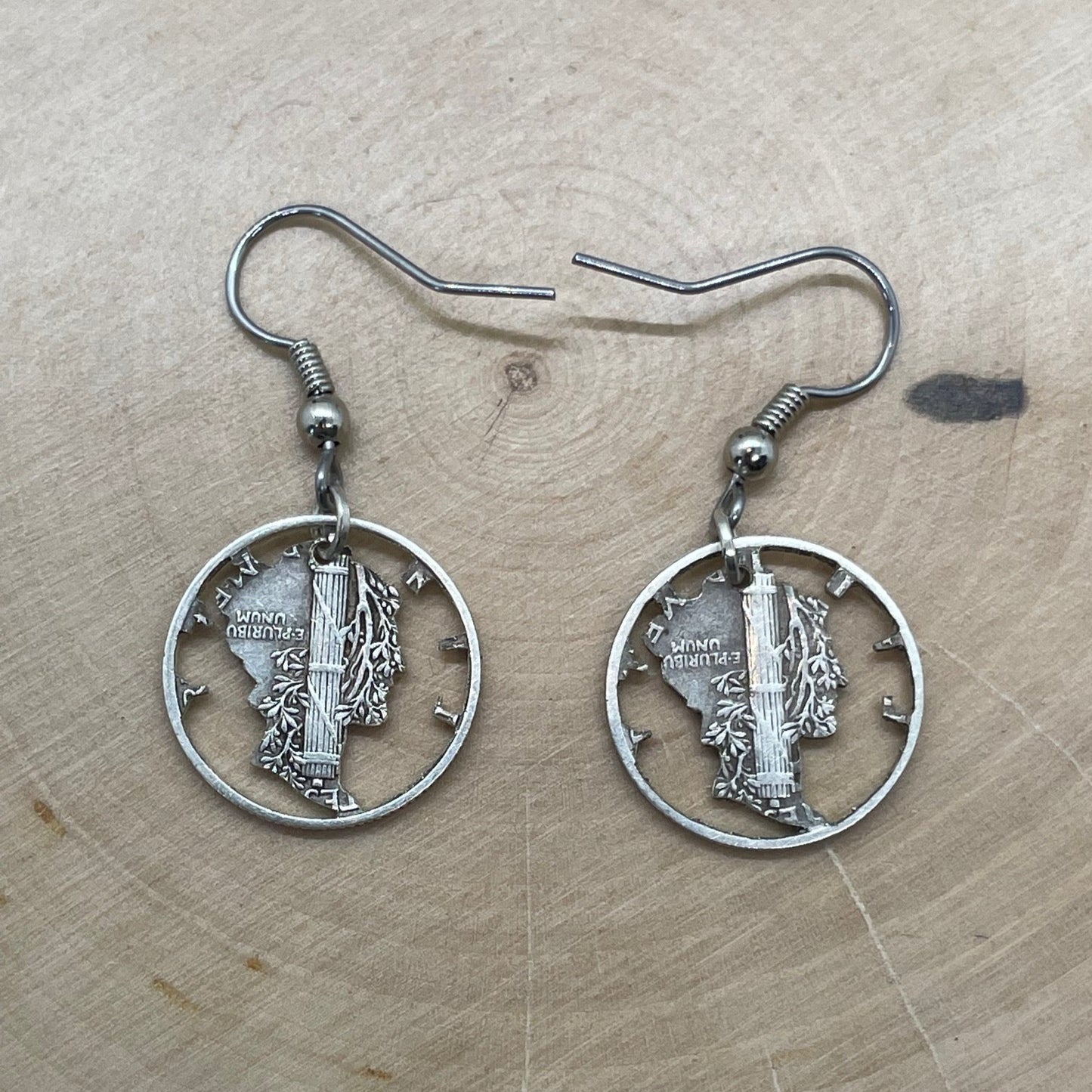 U.S. Mercury Dime Silver Hand Cut Coin Earrings backside on a light wood round. - Mountainstruck Coin Jewelry