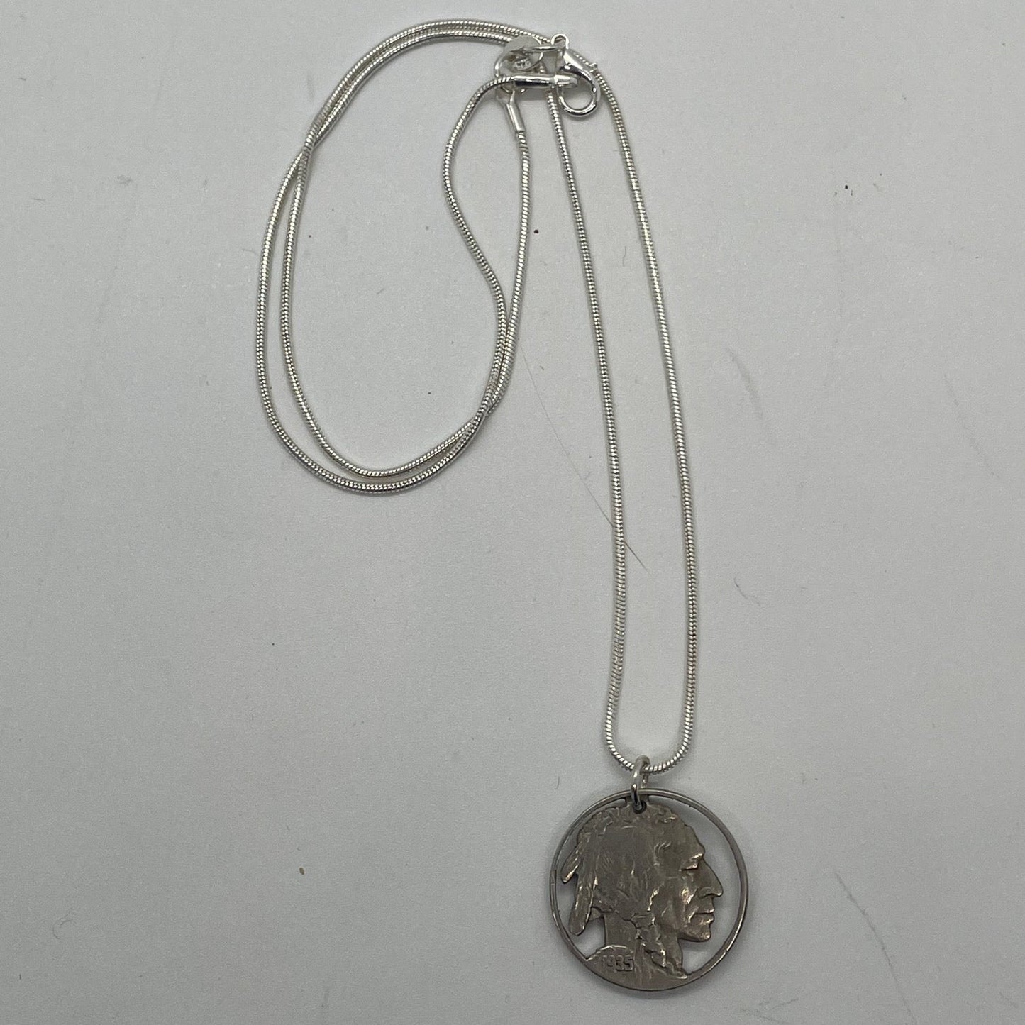 U.S. Buffalo Nickel Hand Cut Coin Necklace (Front) with a snake chain on a white background. - Mountainstruck Coin Jewelry