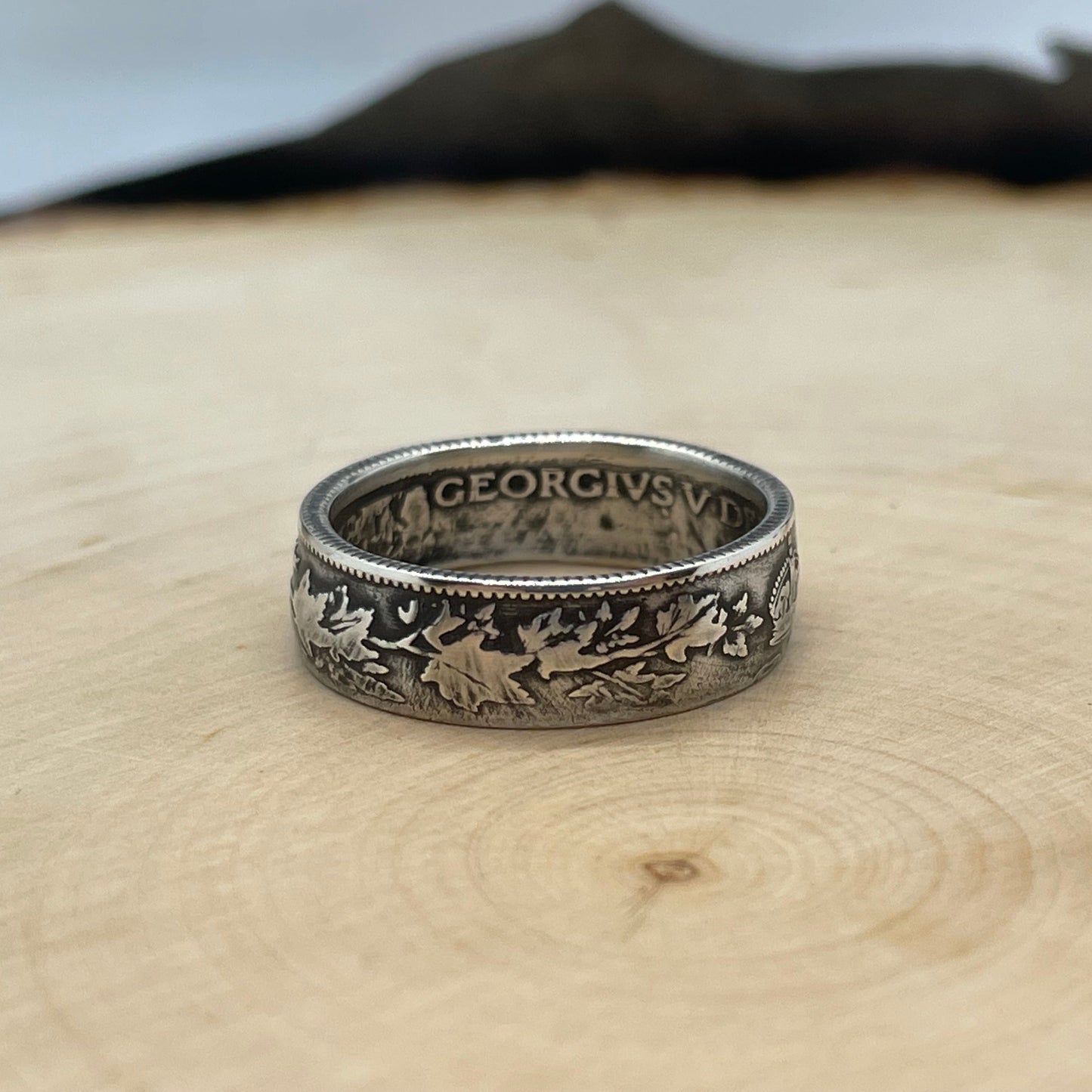 Canada 25 Cents Maple Leaf Silver Coin Ring on a light wood round. - Mountainstruck Coin Jewelry