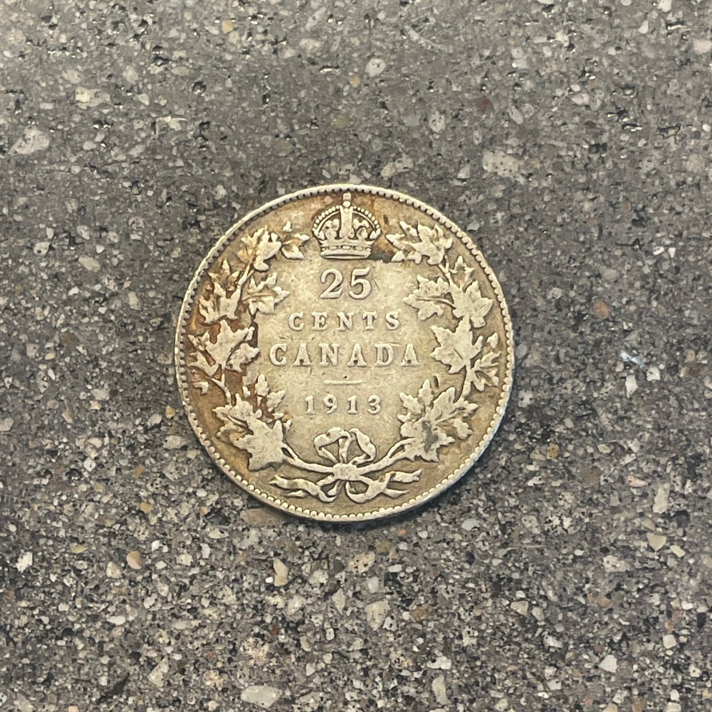 Canada 25 Cents Maple Leaf Silver coin (back) on a concrete background. - Mountainstruck Coin Jewelry