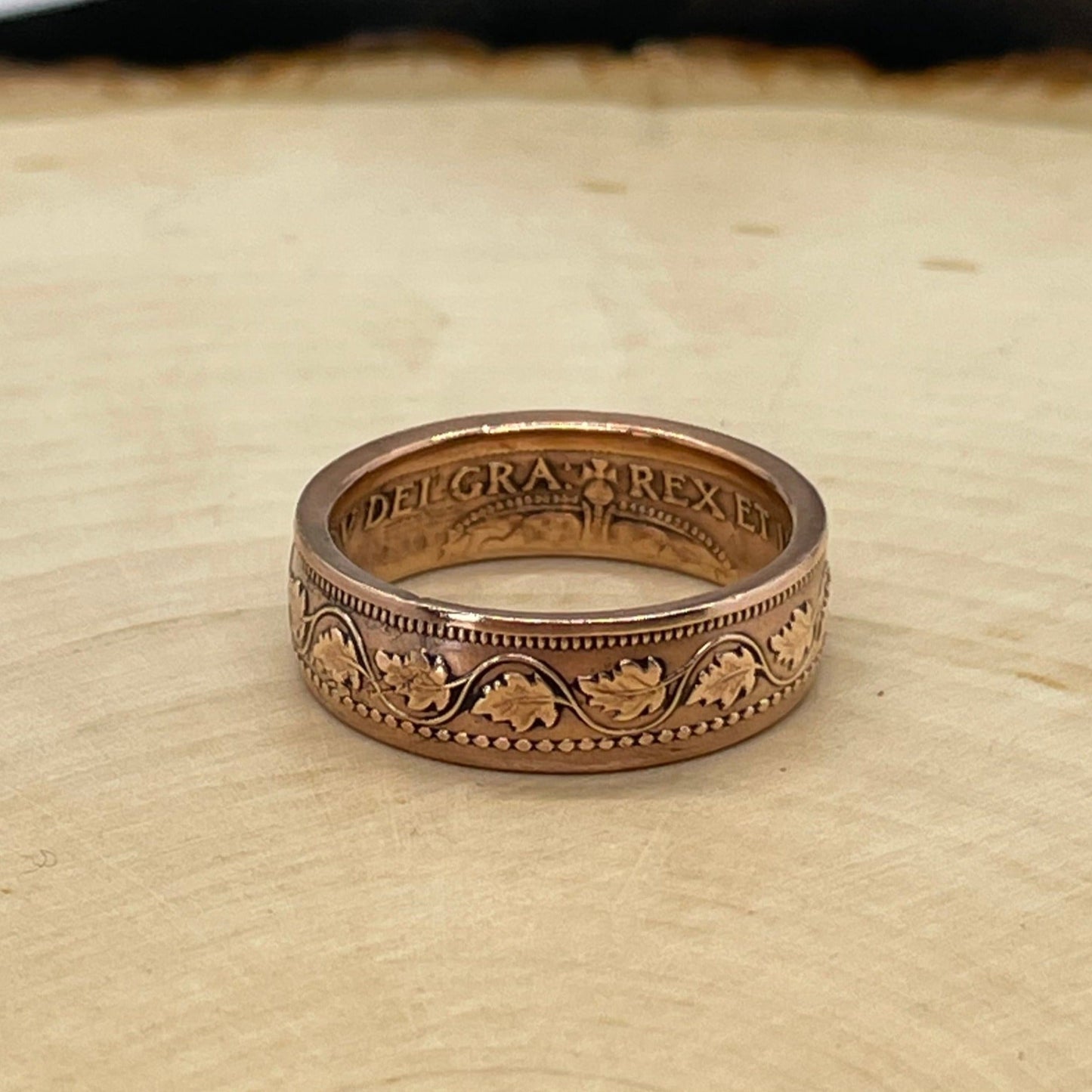 Canada Large Cent Leaf Coin Ring on a light wood round with a mountain outline background. - Mountainstruck Coin Jewelry