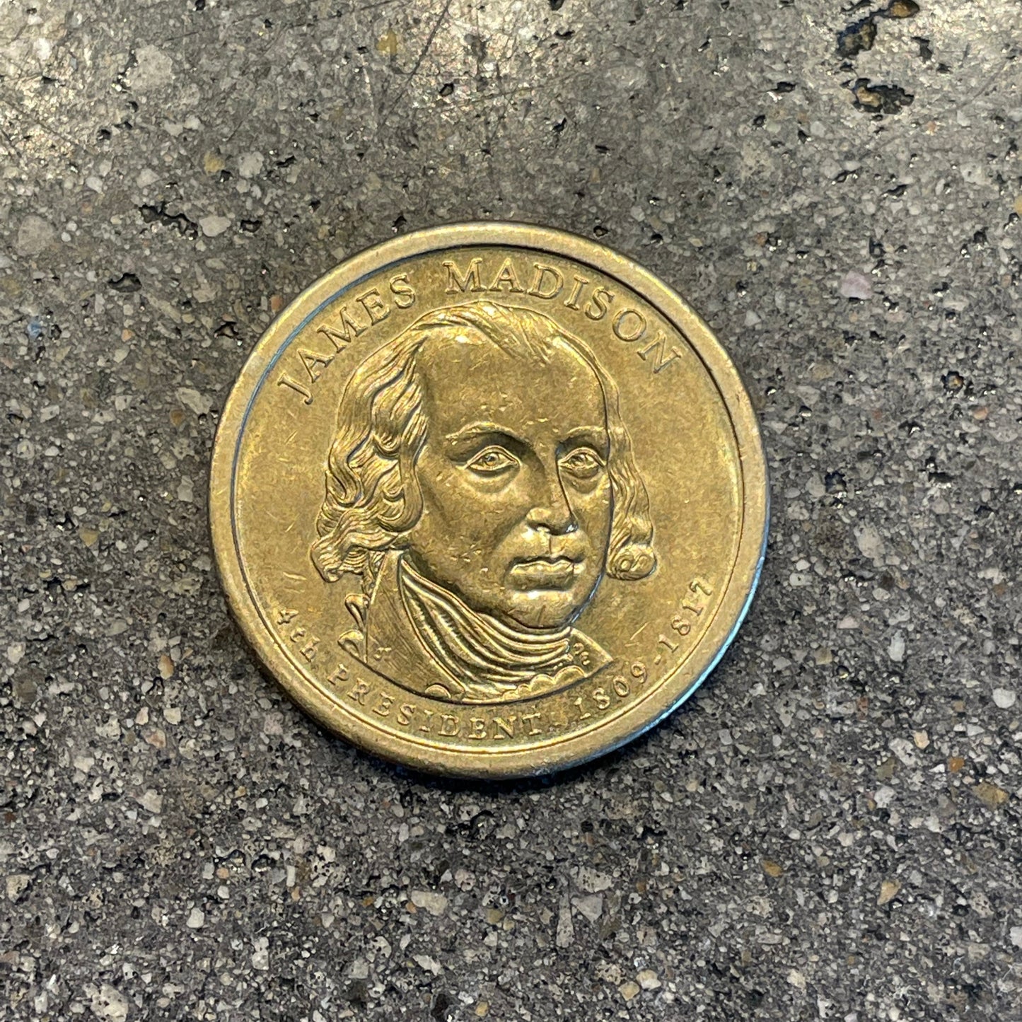 Golden U.S. Presidential Dollar Coin front on a concrete background. - Mountainstruck Coin Jewelry