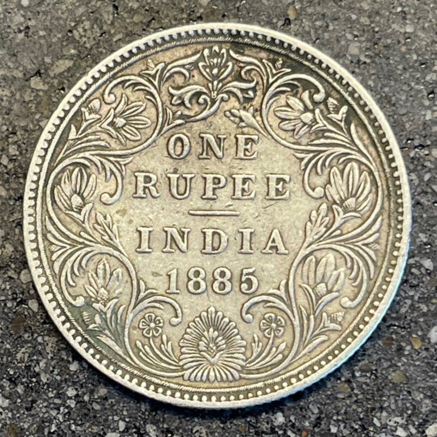 India 1 Rupee Silver Coin (Rare, Victorian) back on a concrete background. - Mountainstruck Coin Jewelry