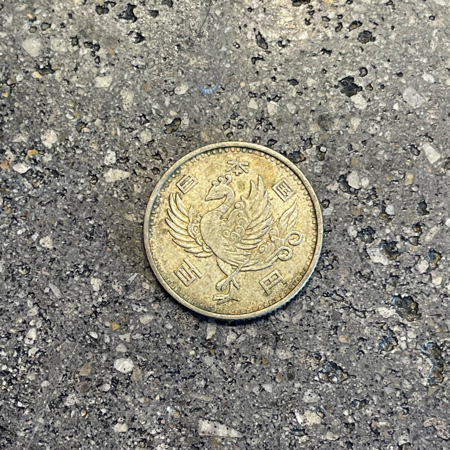 Japan 100 Yen Silver Coin front on a concrete background. - Mountainstruck Coin Jewelry