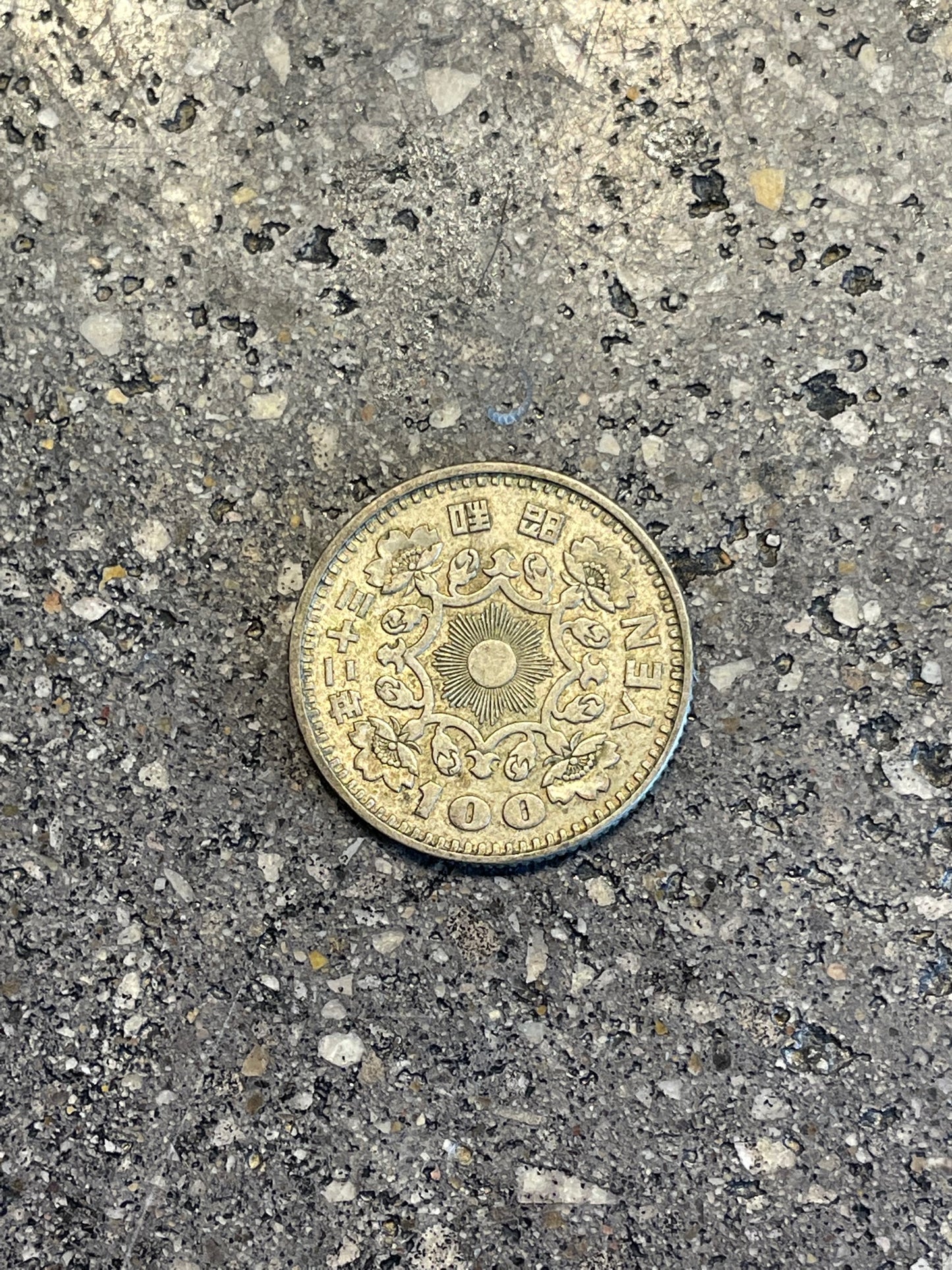 Japan 100 Yen Silver Coin back on a concrete background. - Mountainstruck Coin Jewelry