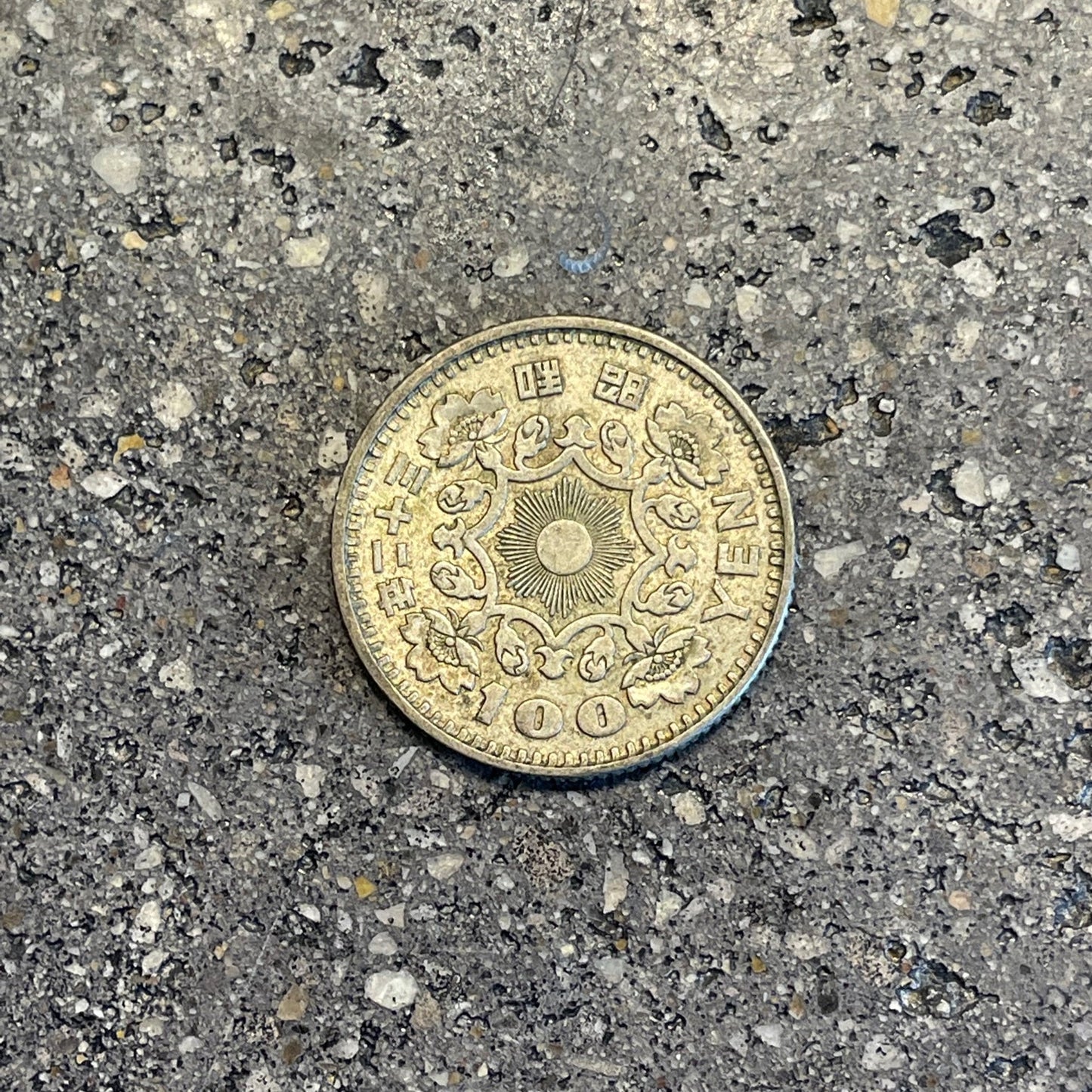 Japan 100 Yen Silver Coin back on a concrete background. - Mountainstruck Coin Jewelry