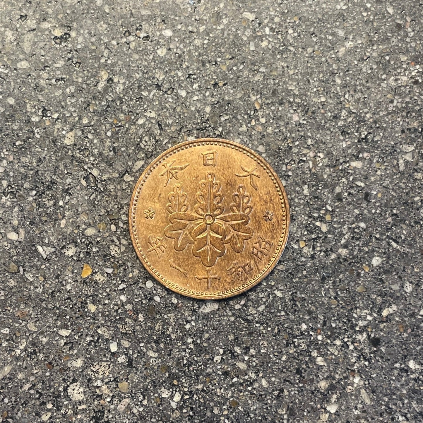 Japan Sen Coin front on a concrete background. - Mountainstruck Coin Jewelry
