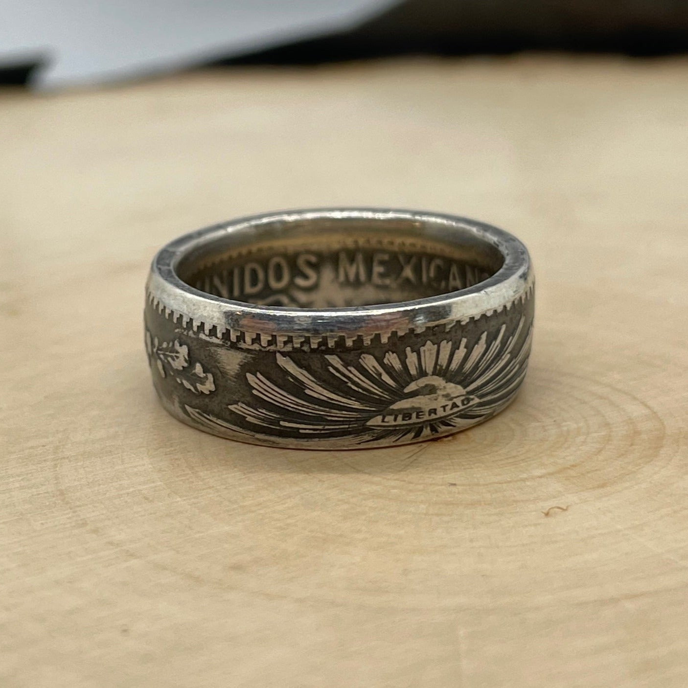 Mexico 50 Centavos Silver Coin Ring (Rare) on a light wood round. - Mountainstruck Coin Jewelry