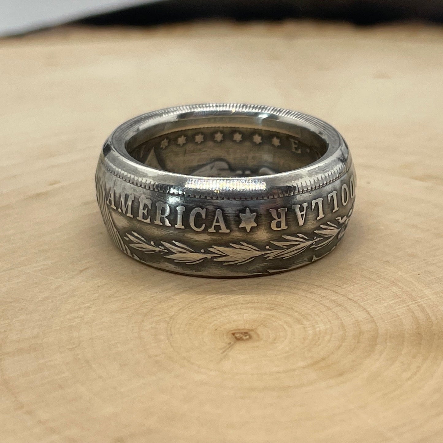 Morgan Dollar Silver Coin Ring on a light wood round. - Mountainstruck Coin Jewelry