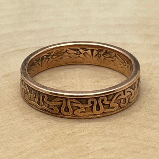 Suriname 1 Cent Coin Ring on a light wood round. - Mountainstruck Coin Jewelry